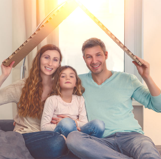Image showing a happy family holding a cardboard roof above their heads